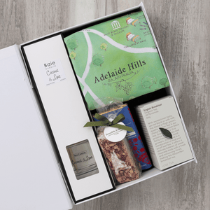 Chocolate, coconut and lime reed diffuser, gourmet nougat, English breakfast tea bags, plus a watercolour-illustrated map cotton tea towel of the Adelaide Hills and matching greeting card in a gift hamper with free delivery