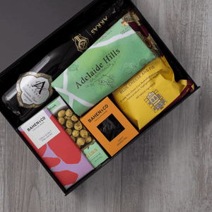 Sparkling wine, gourmet popcorn, artisanal chocolate, hand-roasted macadamias, plus a watercolour-illustrated map cotton tea towel of the Adelaide Hills and matching greeting card in a gift hamper with free delivery