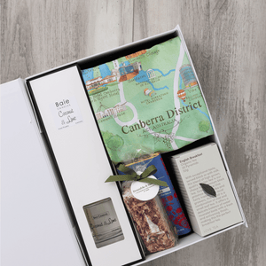 Chocolate, coconut and lime reed diffuser, gourmet nougat, English breakfast tea bags, plus a watercolour-illustrated map cotton tea towel of the Canberra District and matching greeting card in a gift hamper with free delivery