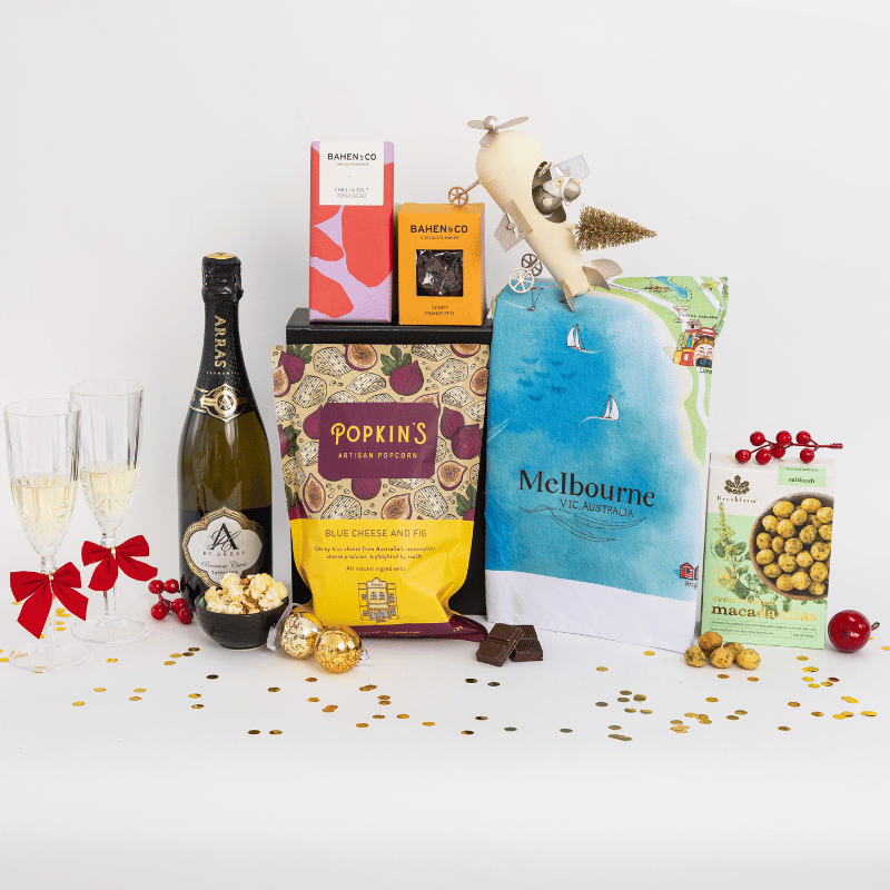 Sparkling wine, gourmet popcorn, artisanal chocolate, hand-roasted macadamias, a cotton tea towel and matching greeting illustrated with your choice of 18 Australian locations in a gift hamper with free delivery