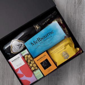 Sparkling wine, gourmet popcorn, artisanal chocolate, hand-roasted macadamias, plus a watercolour-illustrated map cotton tea towel of Melbourne and matching greeting card in a gift hamper with free delivery