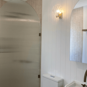 glass clamshell light switched on in bathroom