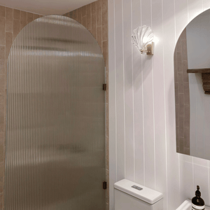 glass clamshell light on in bathroom